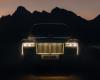 The reflection of skyscrapers in the headlights of an opulent SUV. Rolls-Royce introduces the improved Cullinan